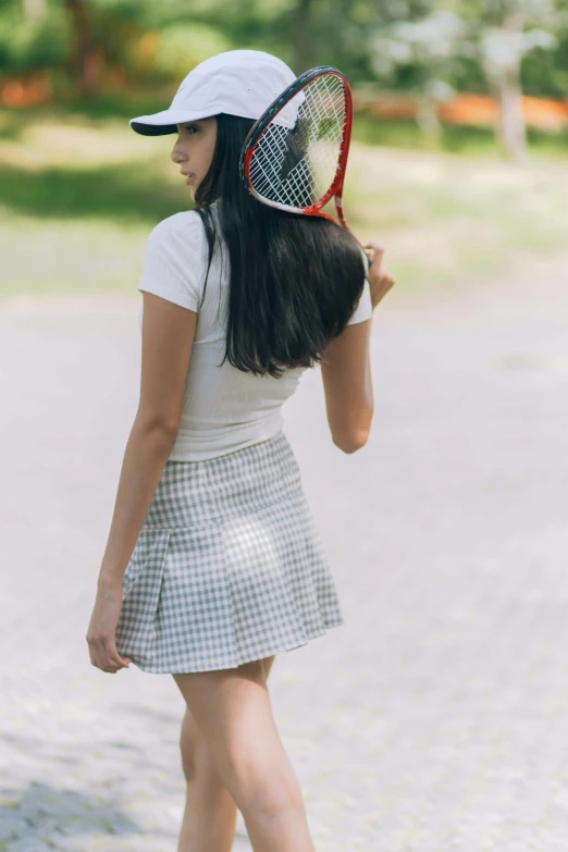 a woman holding onto a tennis racket in her hand