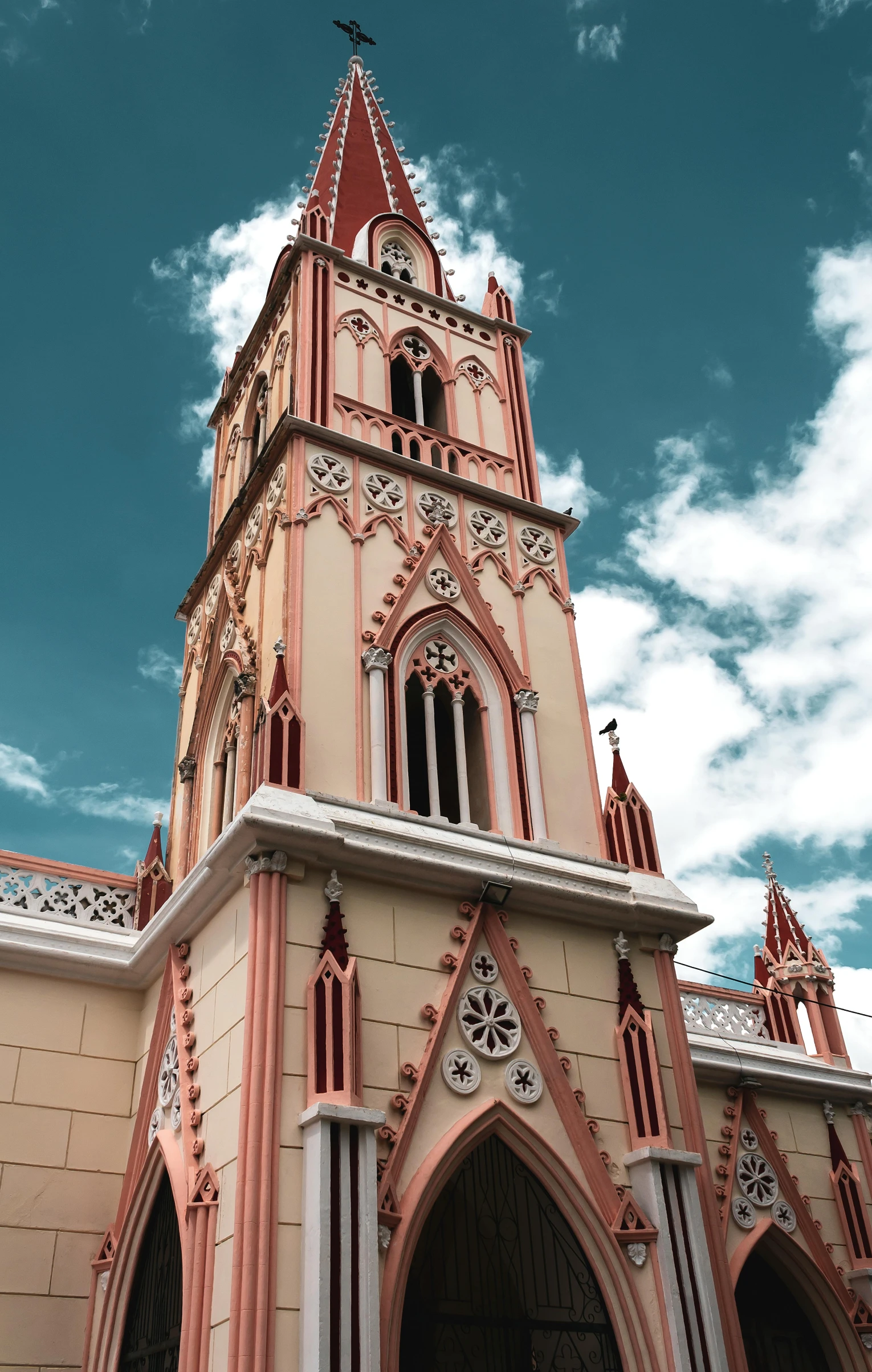 a tall tower with a clock is shown on the side of the building