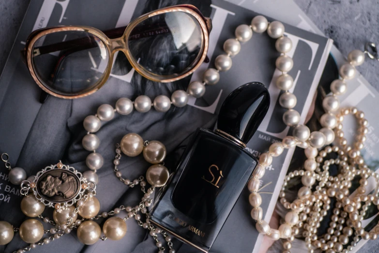 an assortment of jewelry laying out on top of a magazine