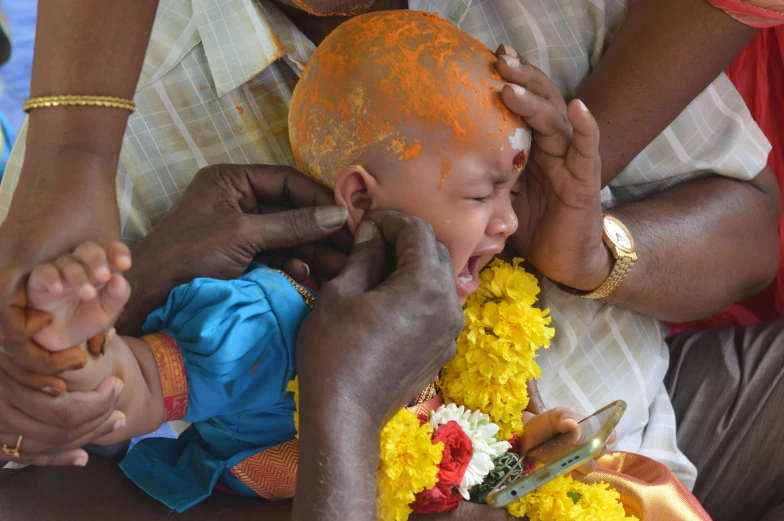 a small child being examined by an adult and woman