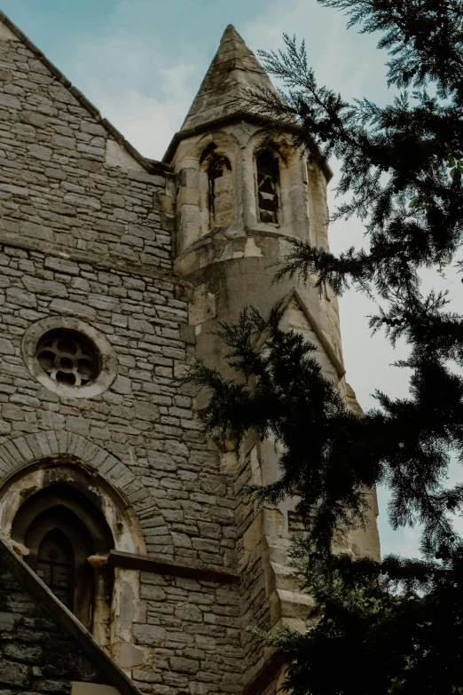 a tall brick church has a tall clock tower