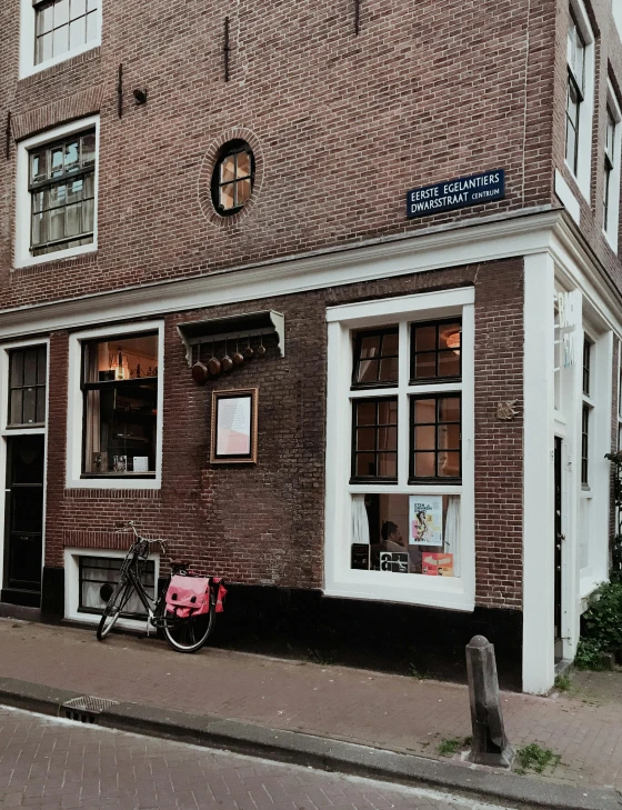 a red bicycle sitting outside a brick building