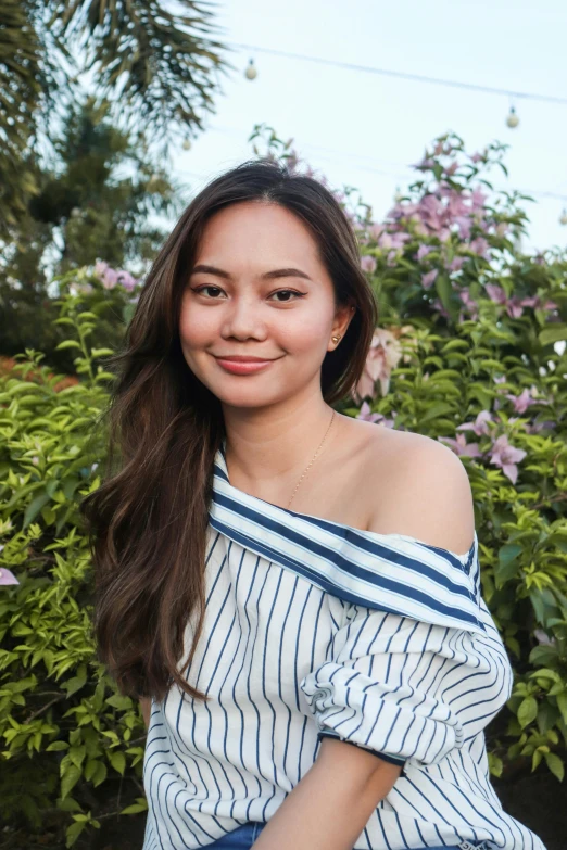 a beautiful young lady wearing a striped shirt