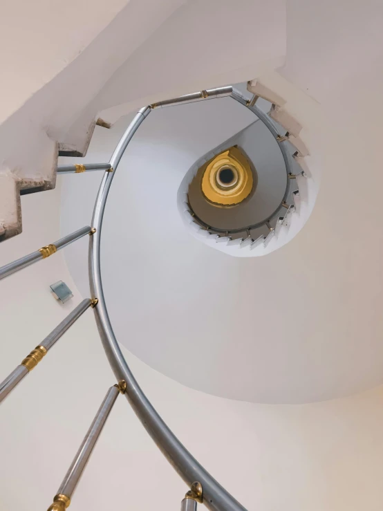 a view of a spiral staircase in an office building