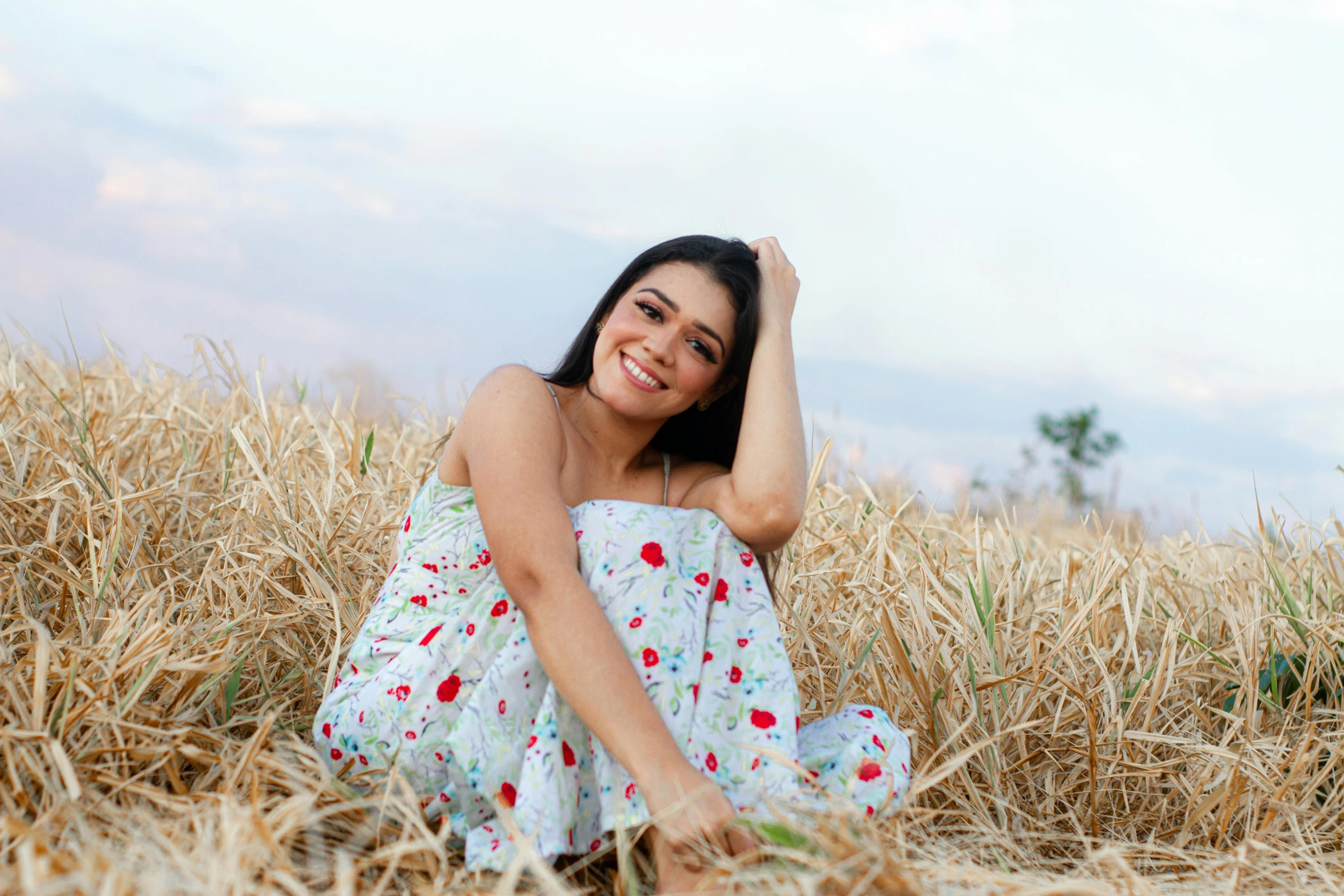 a woman laying in a field on the ground