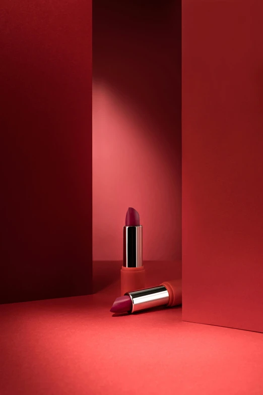 a red wall with a lipstick in the middle