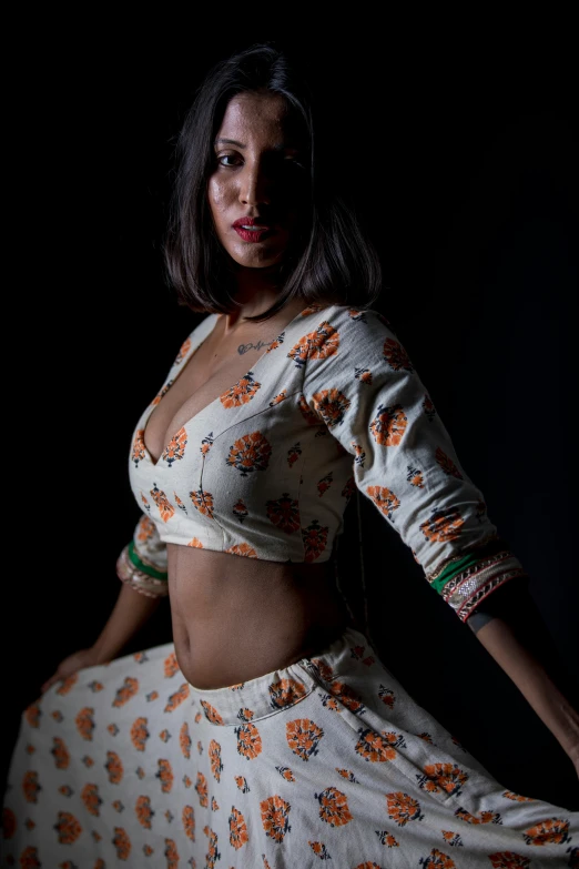 a woman posing in an indian costume and holding her belly