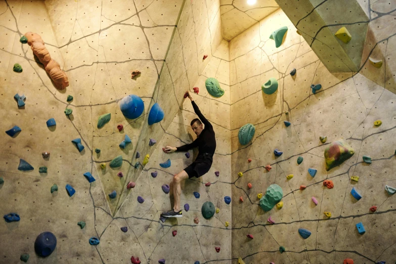 a person standing on a climbing wall