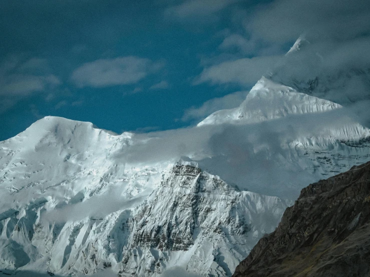 snowy mountains rise above the water at night