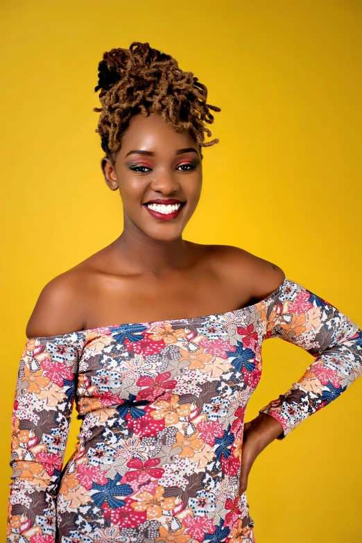 smiling african american woman wearing a top on yellow background