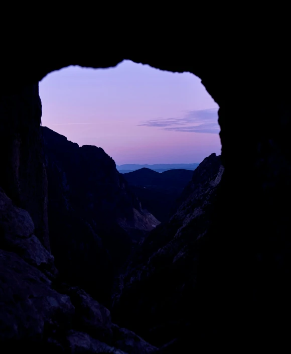 a dark cave that has a few rocks inside