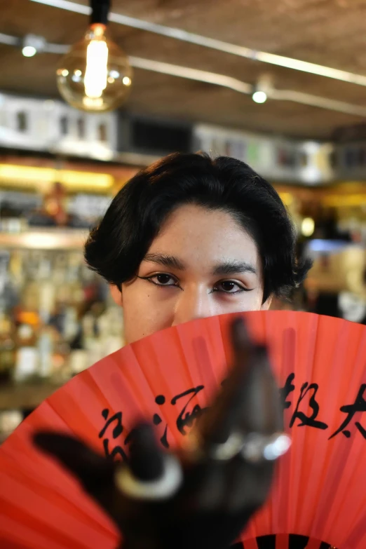 a close up of a person holding a fan with a hand