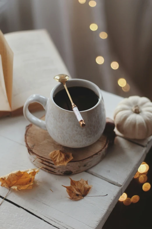 a white cup with a spoon on top of it