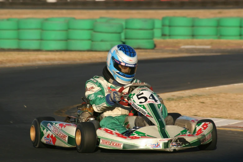 a person riding a kart racing car around a track