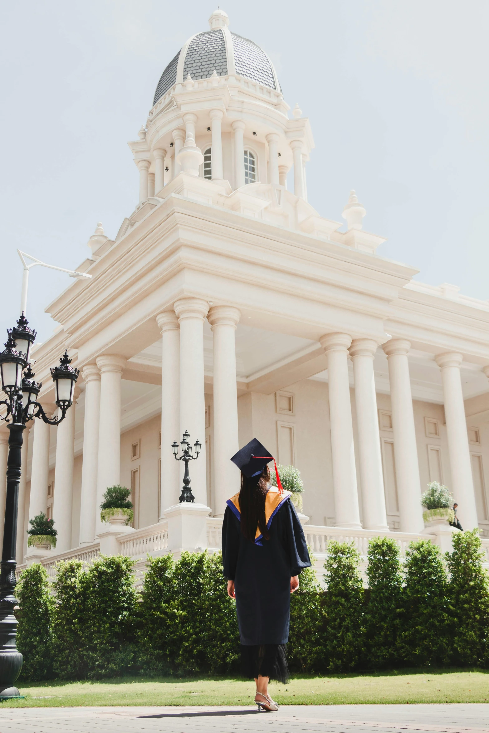 a woman in graduation attire is walking outside