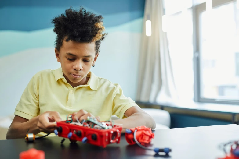 a  playing with legos at a table