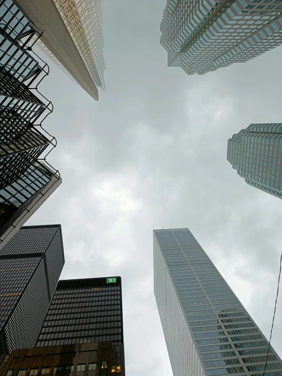 looking up at a sky filled with tall buildings