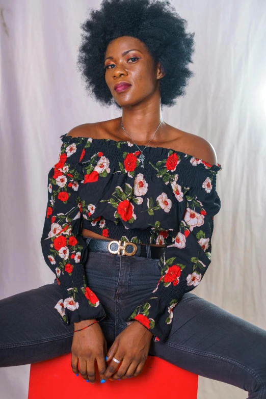 a woman in floral blouse and jeans with black hair