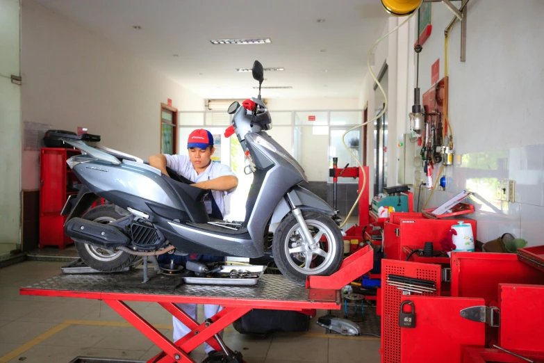 a man working on a motorcycle in a building