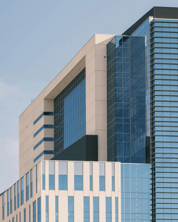 a tall building with lots of windows with an airplane flying in the sky