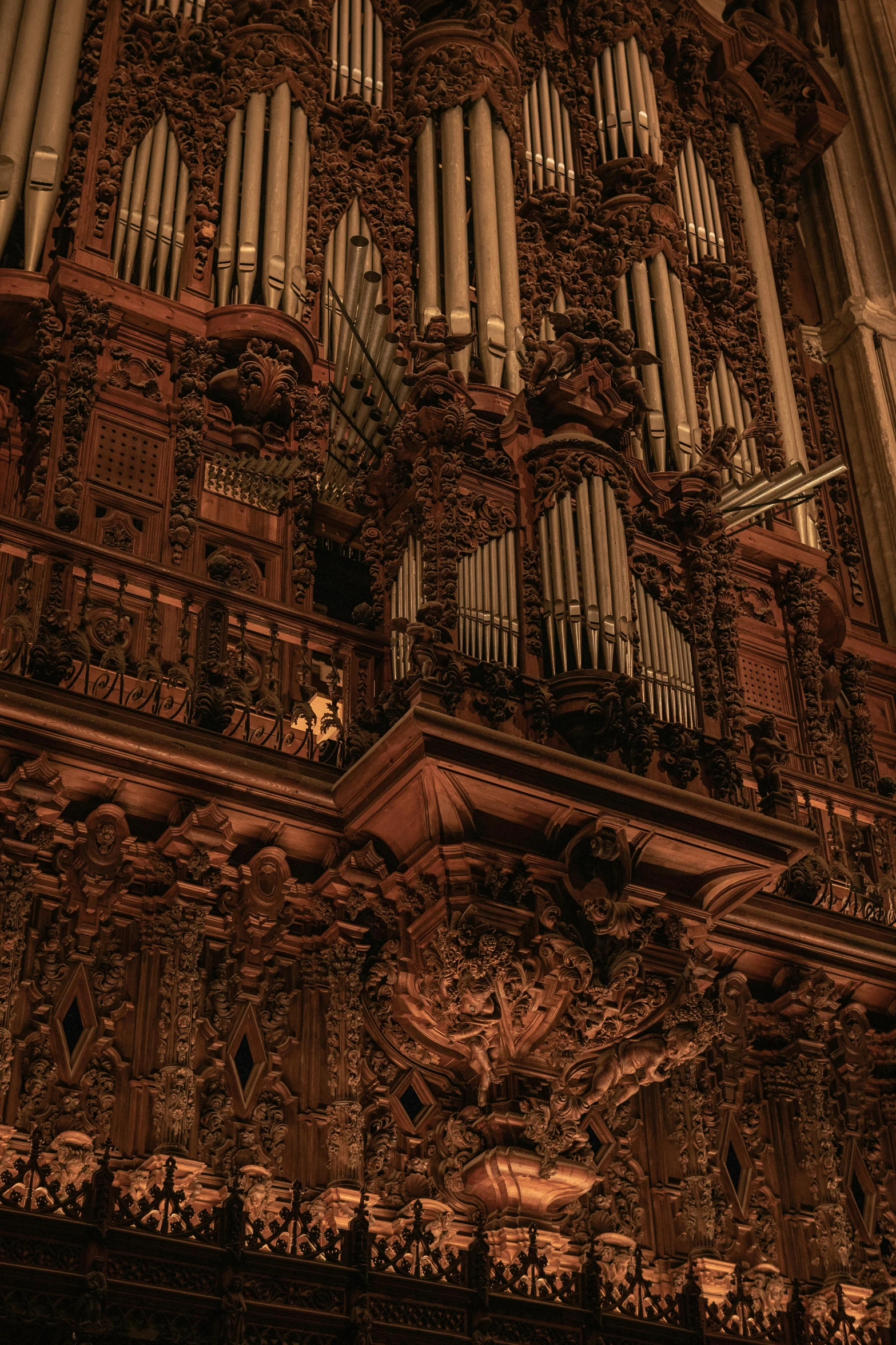 the ornate organ behind the pipe - organ is painted in brown