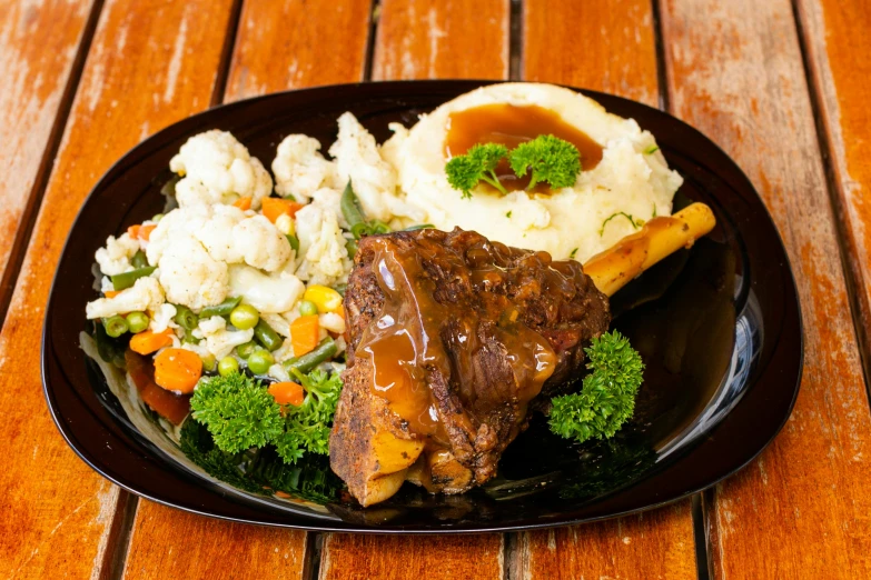 a plate of food on a wooden table