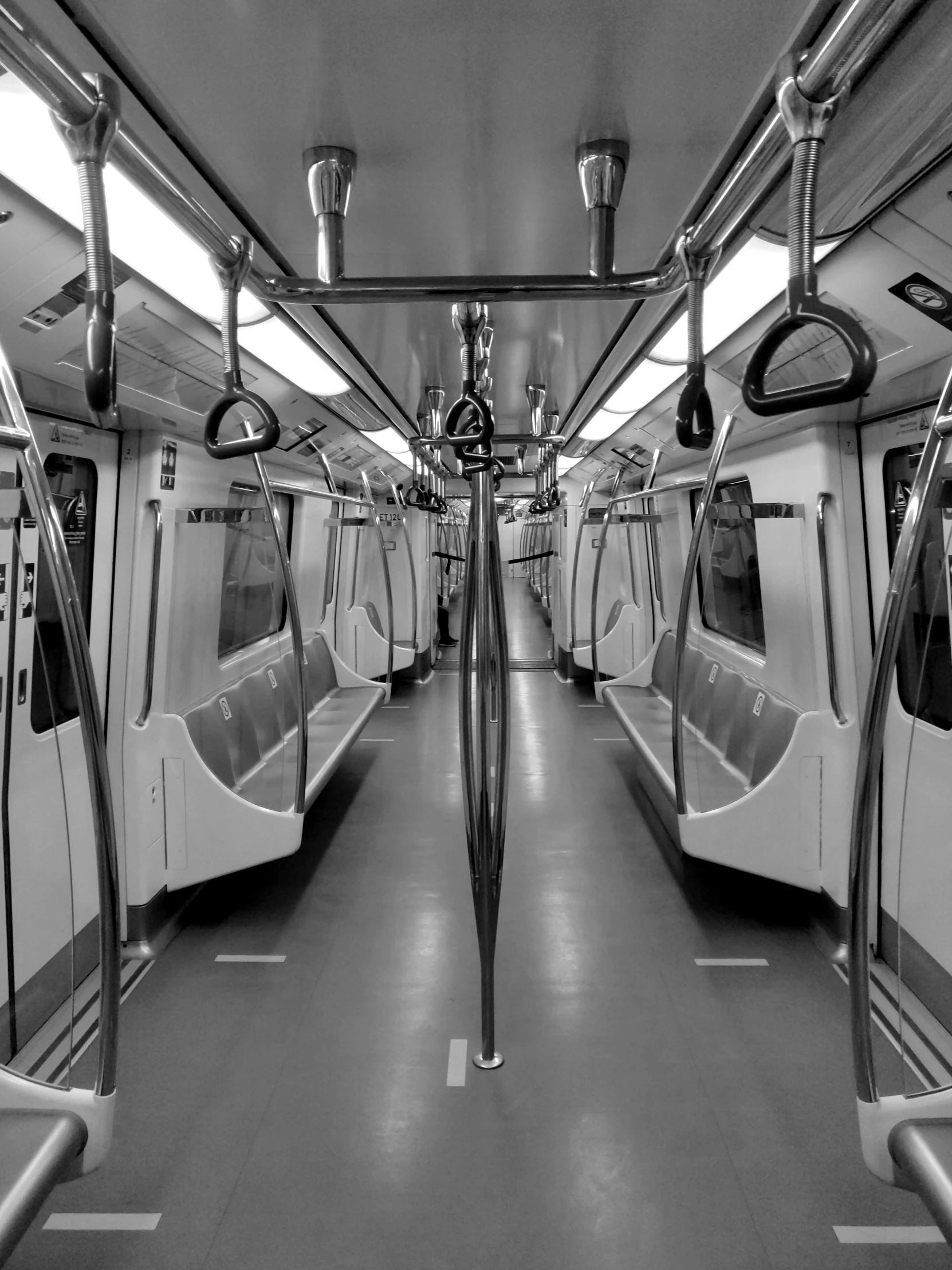 a black and white image of a subway car that has its doors open