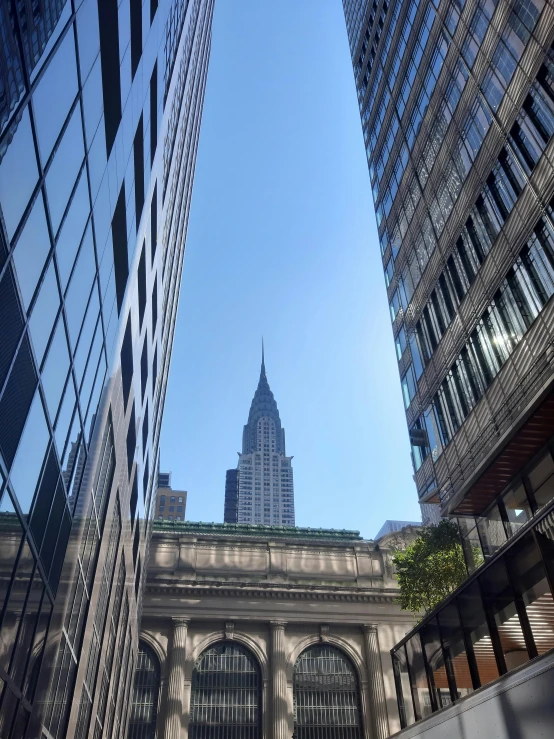 the view of an arch leading to a building with a church on top