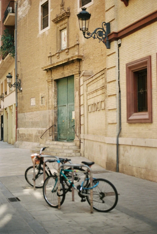 a pair of bikes  to a post in the street