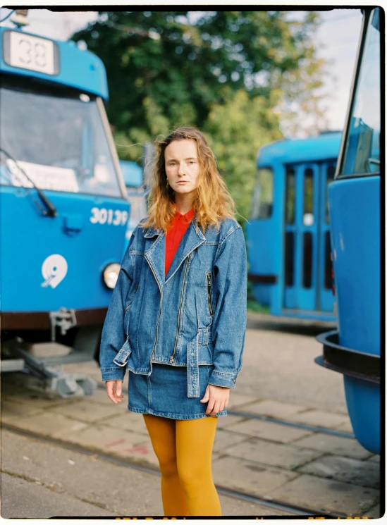 a woman is standing in front of a train