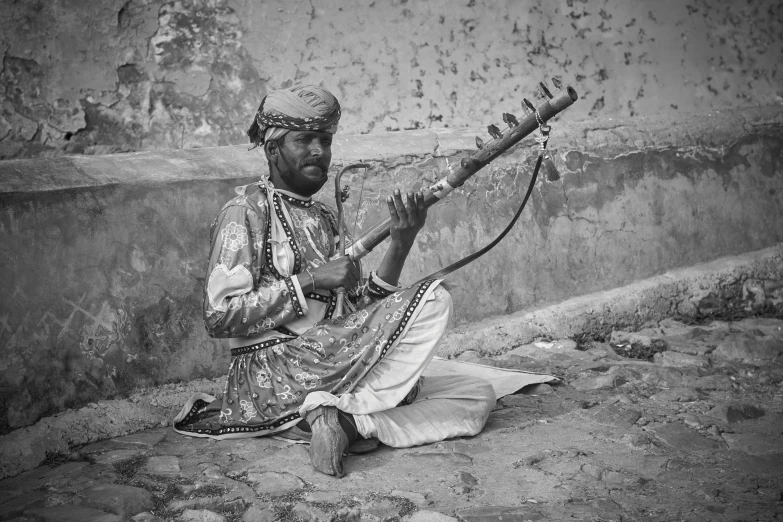 man in an old outfit playing music on a flute