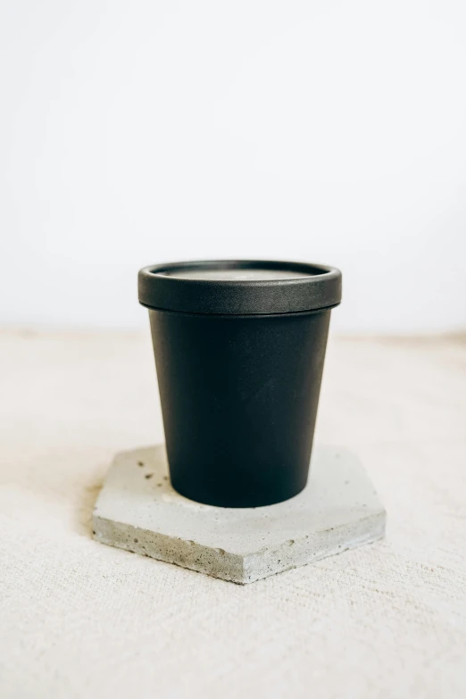 a small black pot sits on top of concrete blocks