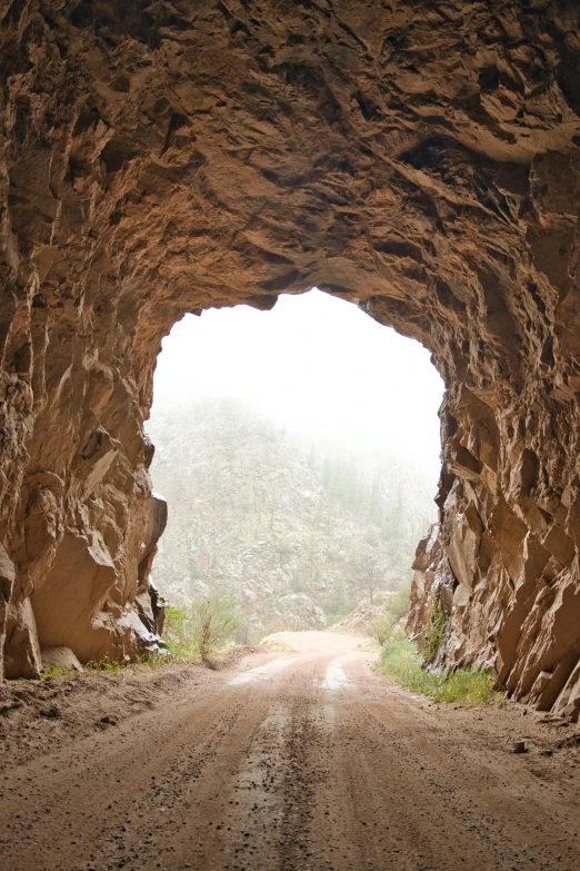 the entrance to a tunnel that is made of rocks