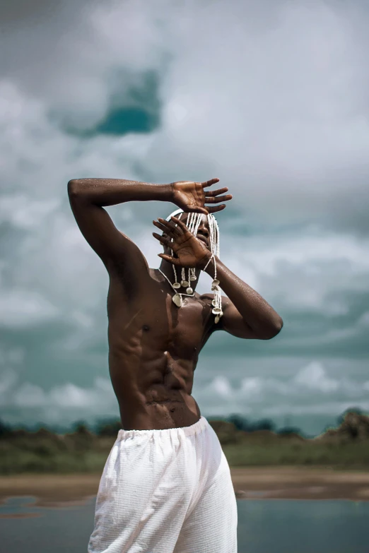 a man in a white shorts is touching his head