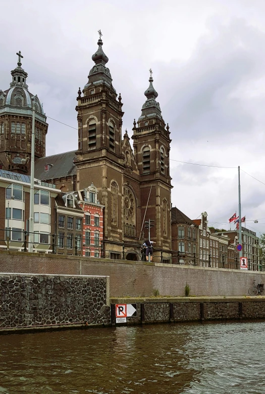 some buildings along the water on a cloudy day