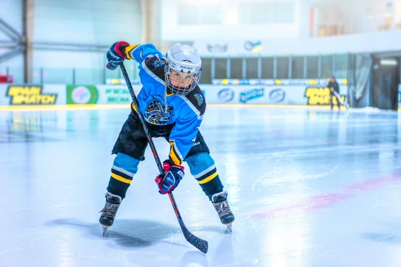 a female hockey player on the ice getting ready to strike the puck