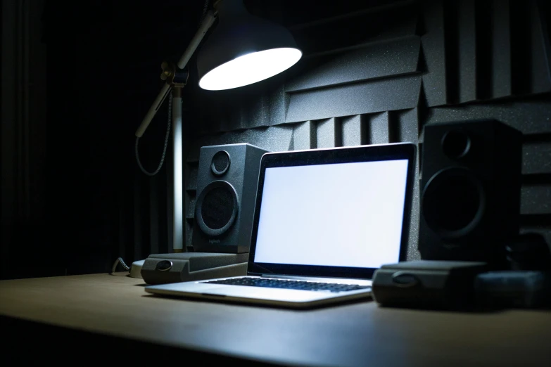 a laptop with an empty white screen sitting on a desk