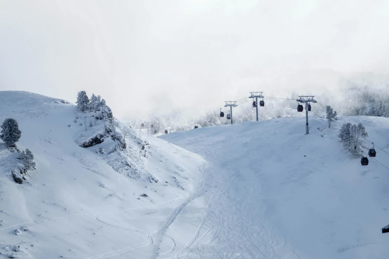 a view of a ski lift at a snow covered mountain