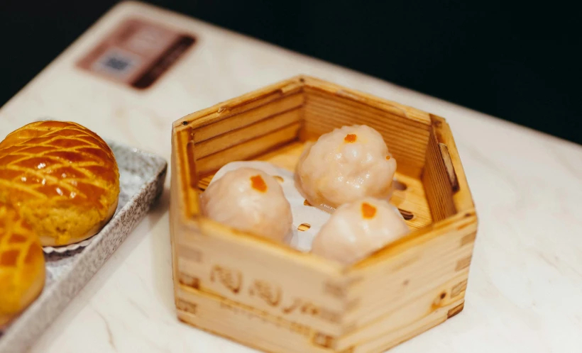 a close up view of a wooden box filled with doughnuts