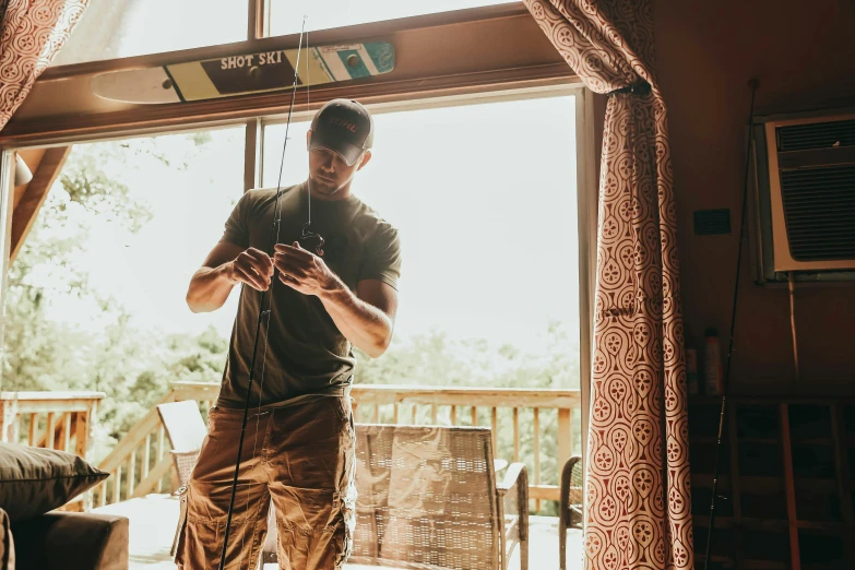 the man looks at his cell phone while standing in front of the open door