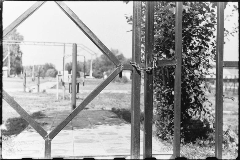 black and white po of a gated in park with lots of trees