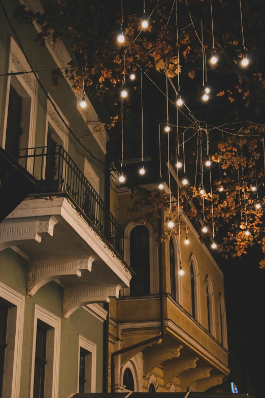 a row of lights hanging from the ceiling over a building