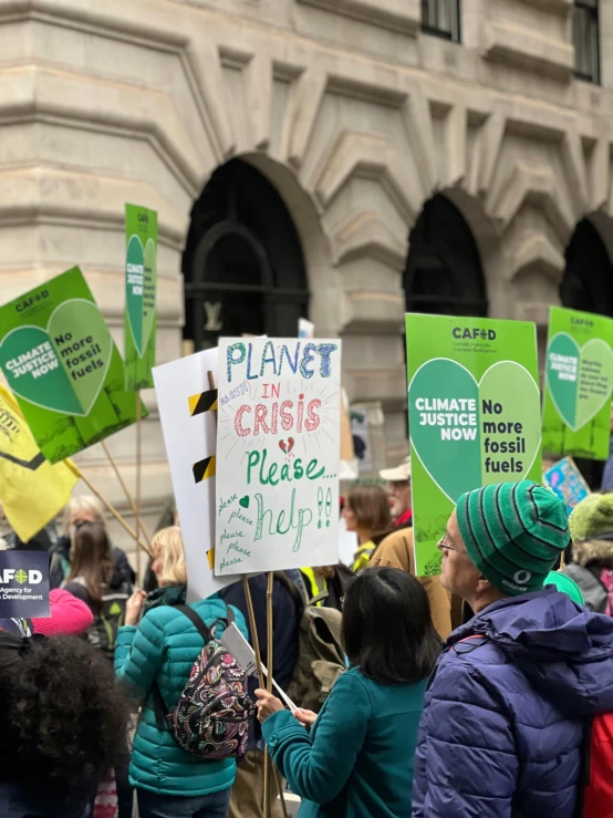 large group of people holding up protest signs