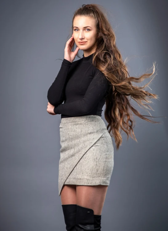 woman with long brown hair leaning on her head