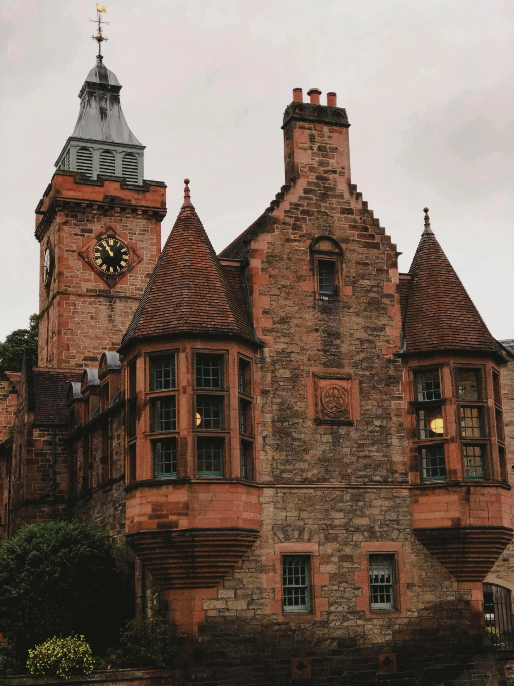 an ornate building with two towers and a clock tower