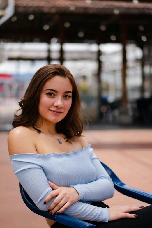 a woman is posing for a po with her legs crossed