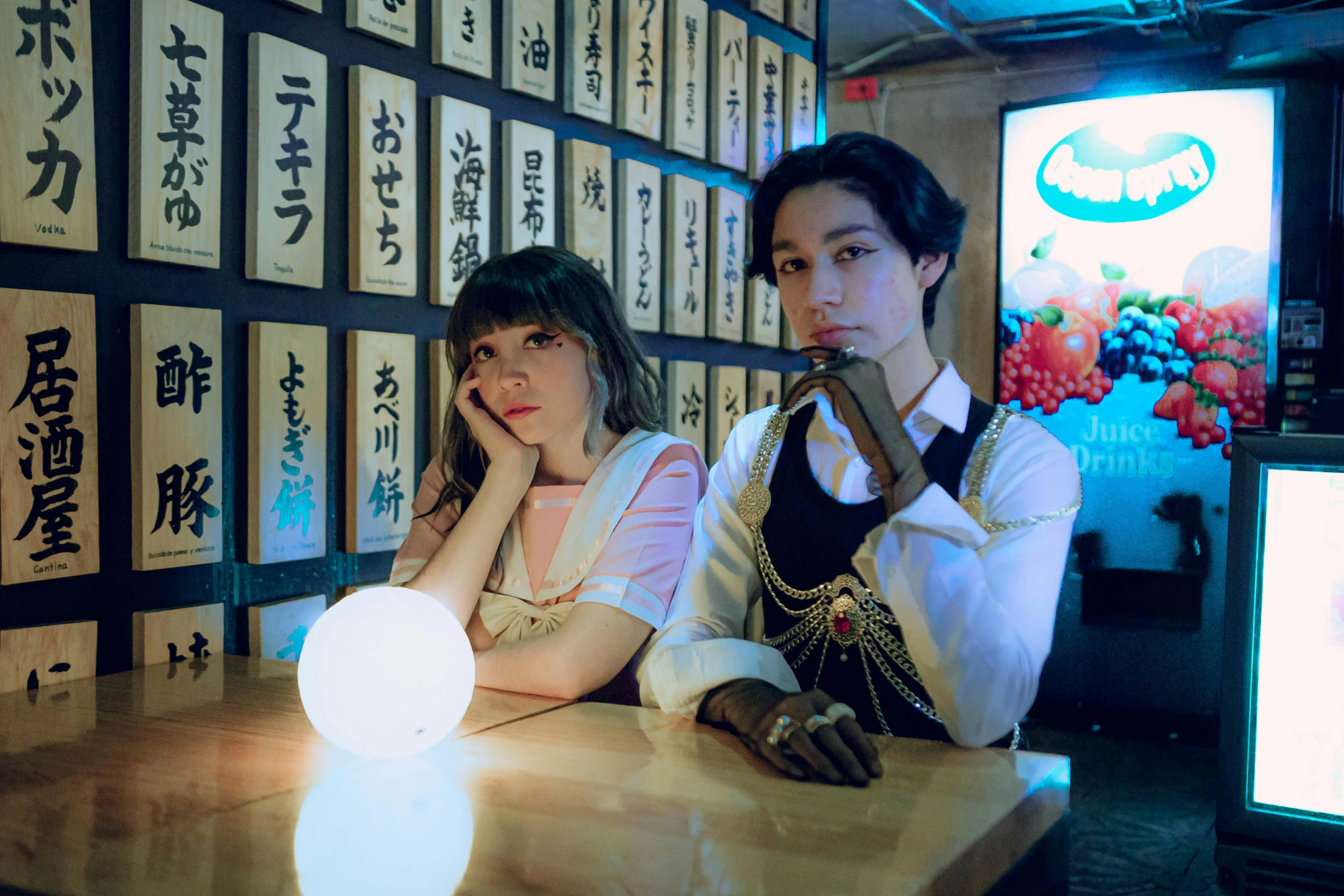 two young asian women at a counter in a shop