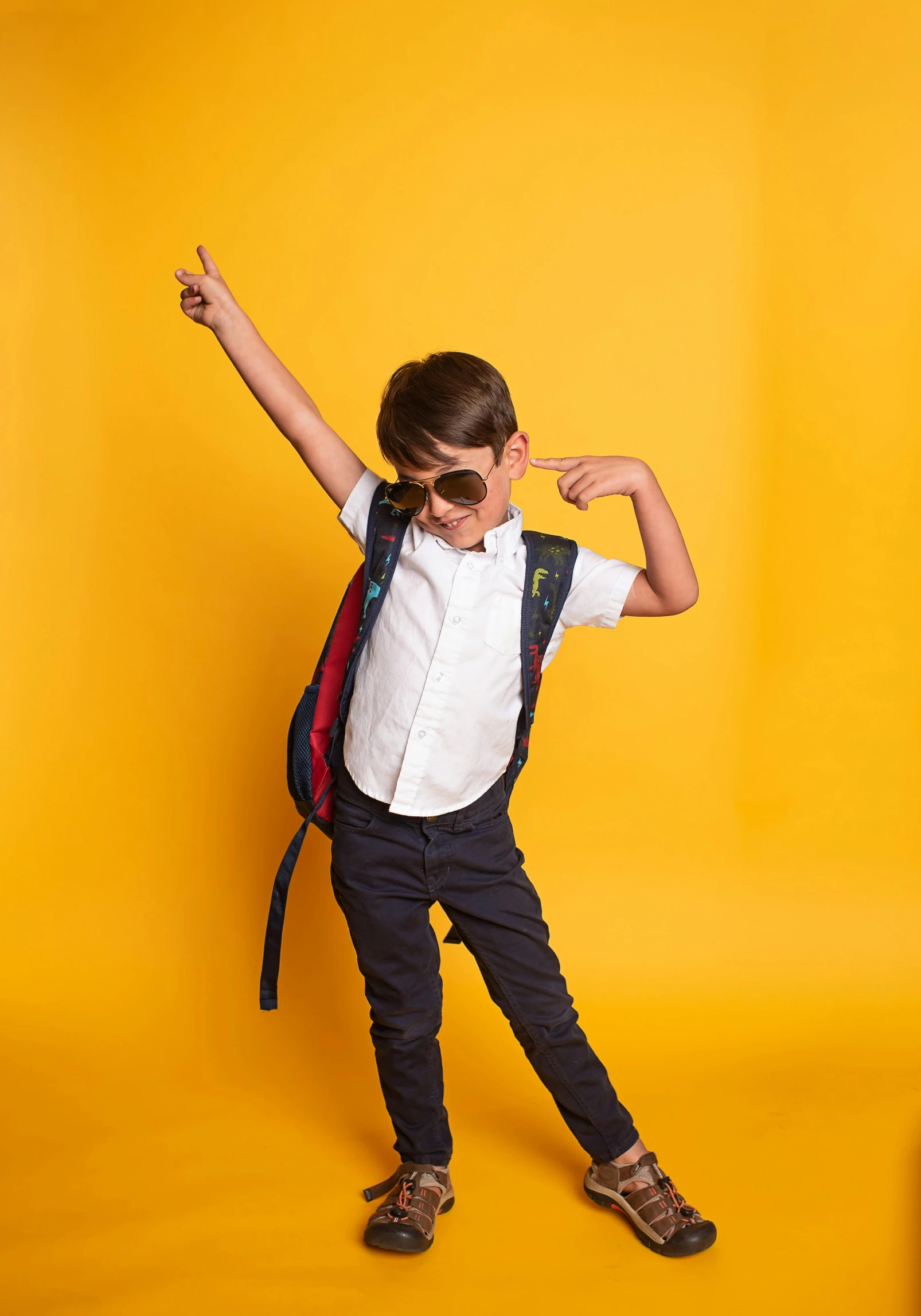  posing with back pack and yellow background