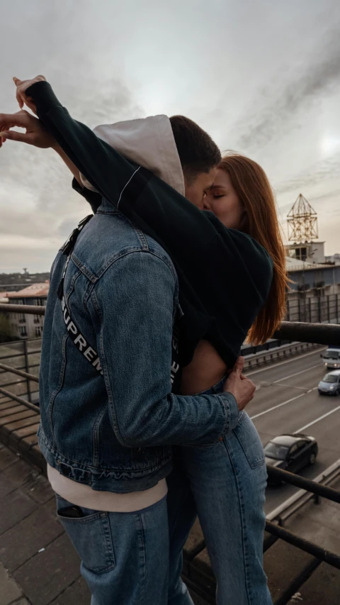 a man holding on to the back of a woman who is cuddling her head with him