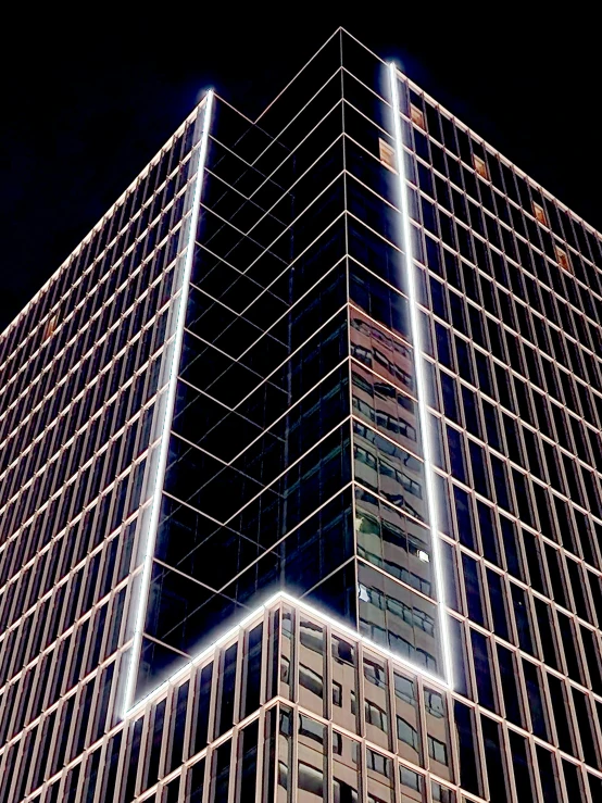 the view of a skyscr at night shows a very high rise
